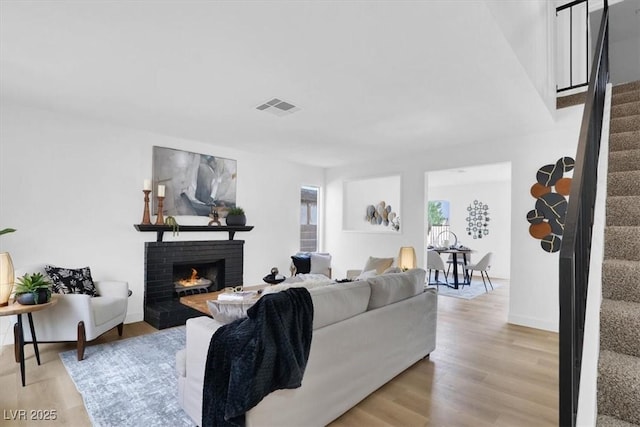 living room with a fireplace and light hardwood / wood-style flooring