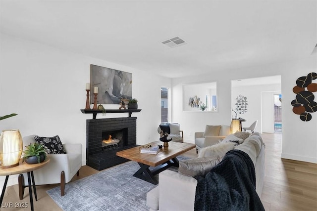 living room with a fireplace and hardwood / wood-style floors