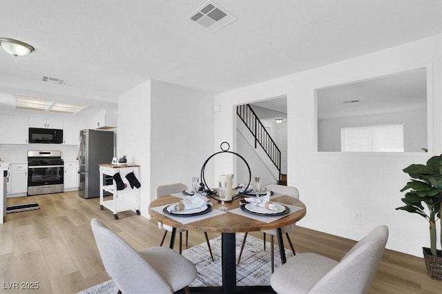 dining space featuring light hardwood / wood-style floors