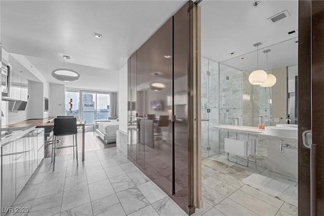 interior space with vanity and an enclosed shower