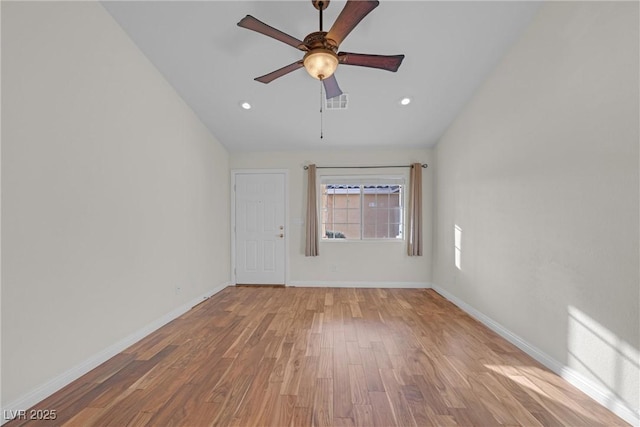 spare room featuring light hardwood / wood-style flooring, ceiling fan, and vaulted ceiling