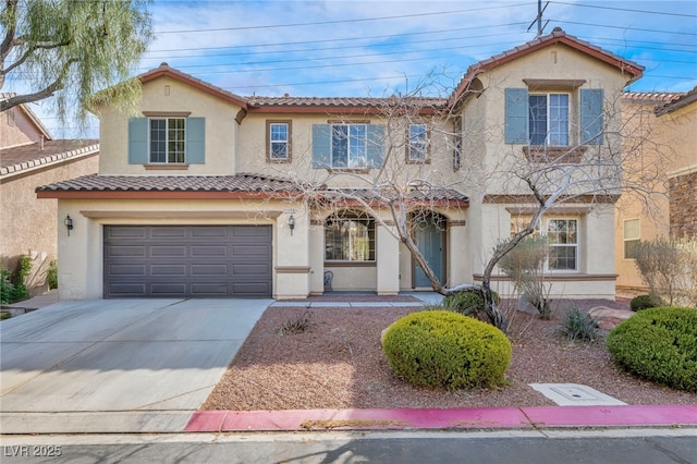 mediterranean / spanish-style home with a tile roof, an attached garage, driveway, and stucco siding