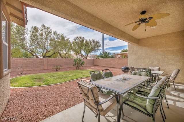 view of patio / terrace featuring ceiling fan, a fenced backyard, and outdoor dining space