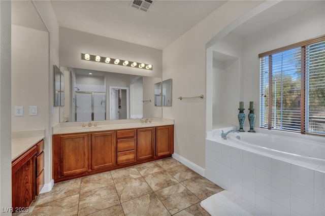 bathroom featuring visible vents, double vanity, a sink, a shower stall, and a bath