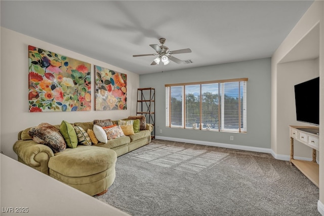 carpeted living room with visible vents, baseboards, and a ceiling fan