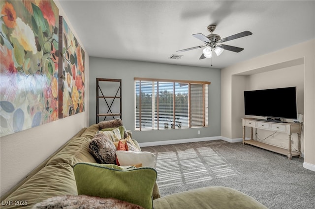 living room with visible vents, baseboards, a ceiling fan, and carpet flooring