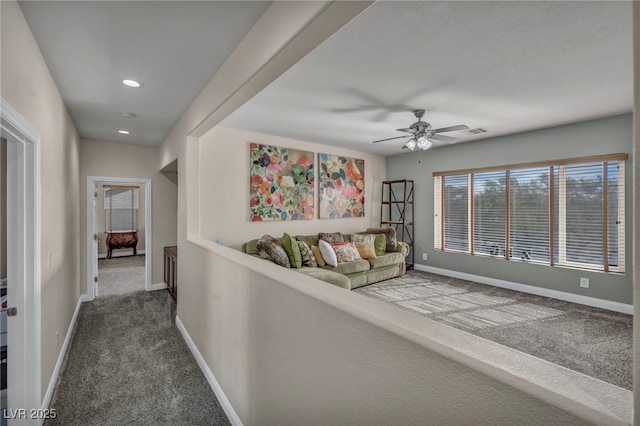 hallway featuring recessed lighting, visible vents, baseboards, and dark carpet