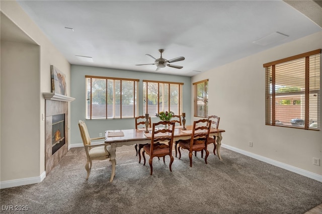 dining room with a wealth of natural light, a fireplace, and carpet floors