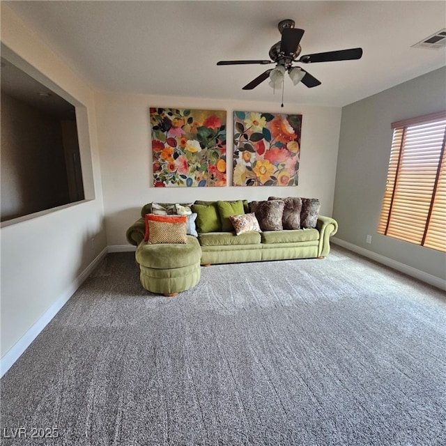 interior space with visible vents, carpet floors, baseboards, and a ceiling fan