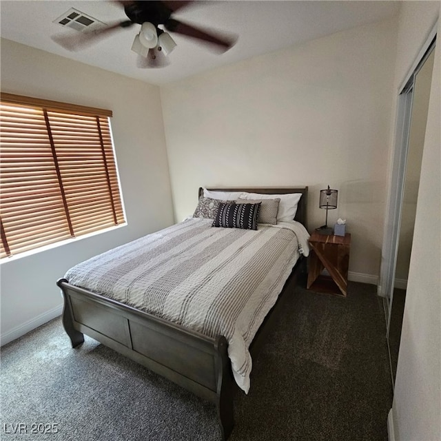 carpeted bedroom with visible vents, baseboards, and a ceiling fan