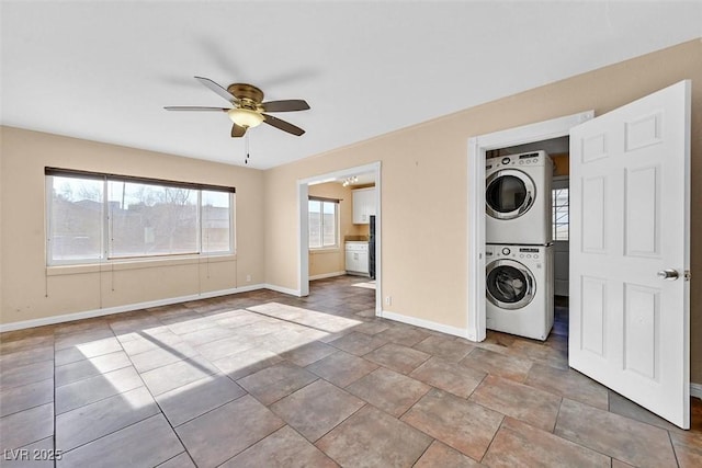 washroom featuring stacked washer and dryer and ceiling fan