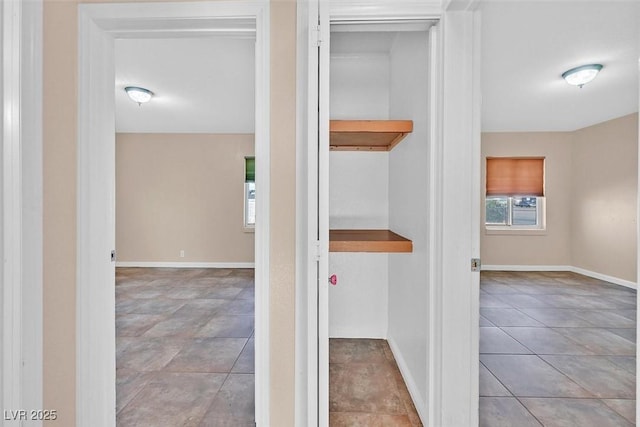 hall with light tile patterned floors