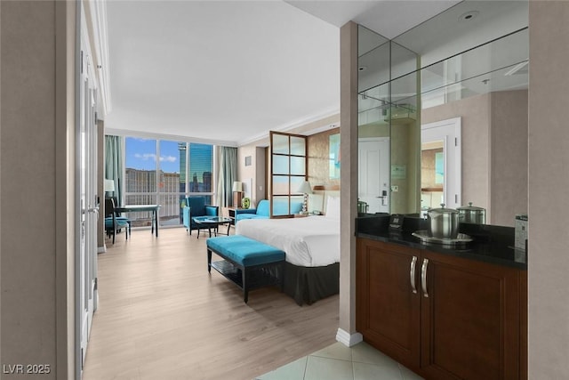 bathroom featuring a view of city, a wall of windows, and wood finished floors