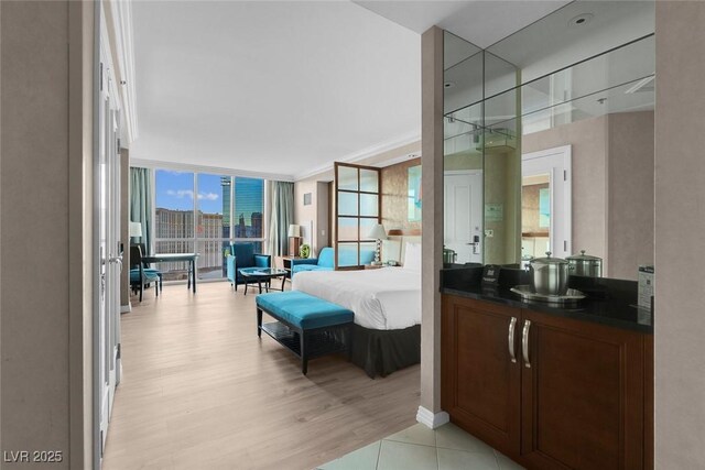 145 E Harmon Ave Unit 2603, Las Vegas, NV 89109 - bathroom featuring expansive windows, wood finished floors, and vanity