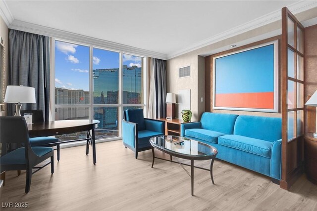 145 E Harmon Ave Unit 2603, Las Vegas, NV 89109 - living area with a wall of windows, ornamental molding, and wood finished floors