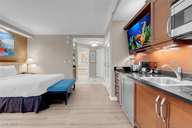 145 E Harmon Ave Unit 2603, Las Vegas, NV 89109 - bedroom with a sink, light wood-style floors, ornamental molding, and ensuite bathroom