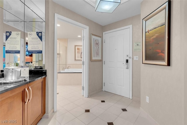 145 E Harmon Ave Unit 2603, Las Vegas, NV 89109 - bathroom featuring a bath, vanity, baseboards, and tile patterned floors