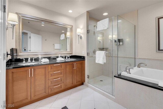 145 E Harmon Ave Unit 2603, Las Vegas, NV 89109 - full bath with double vanity, a shower stall, a garden tub, tile patterned floors, and recessed lighting