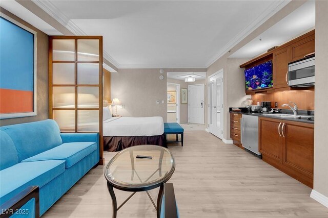 145 E Harmon Ave Unit 2603, Las Vegas, NV 89109 - living room featuring light wood-style flooring, ornamental molding, and baseboards