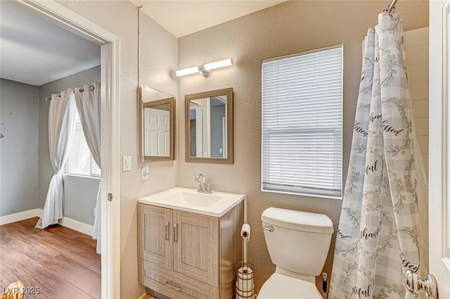 bathroom with hardwood / wood-style flooring, vanity, a shower with curtain, and toilet