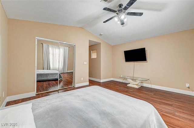 unfurnished bedroom with wood-type flooring, vaulted ceiling, and ceiling fan