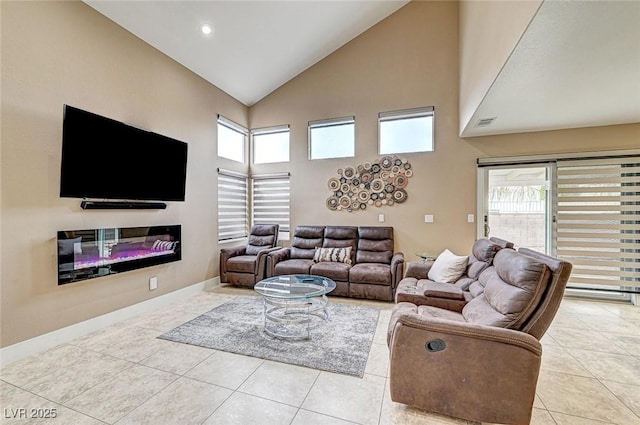 living room with light tile patterned floors and high vaulted ceiling