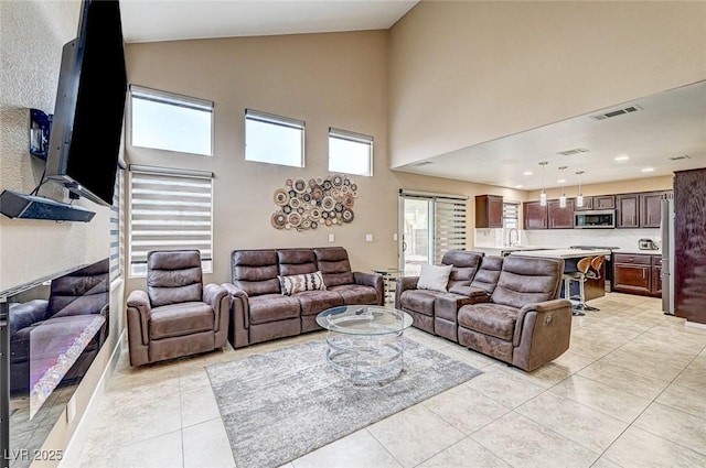 tiled living room with high vaulted ceiling and sink