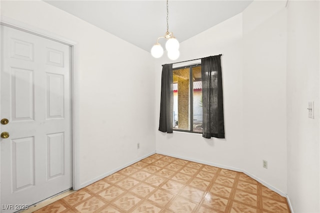 empty room with vaulted ceiling and a chandelier