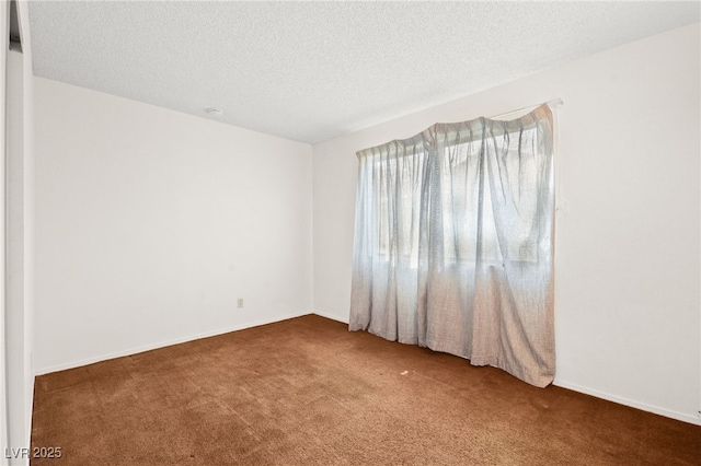 unfurnished room featuring a textured ceiling and carpet flooring