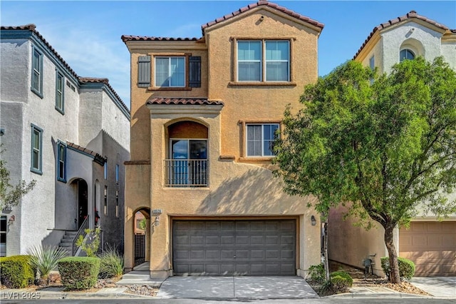 mediterranean / spanish home featuring a garage