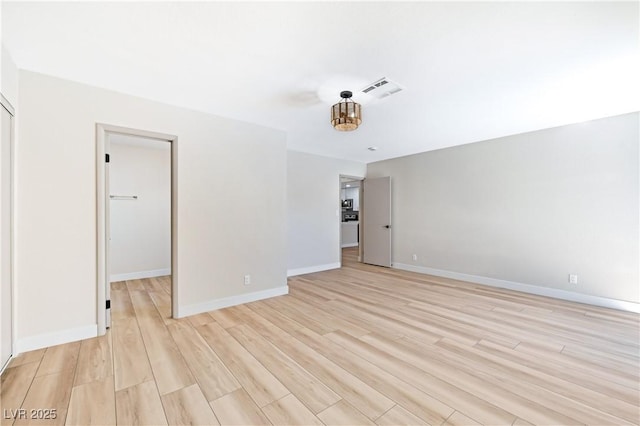 spare room with light hardwood / wood-style flooring