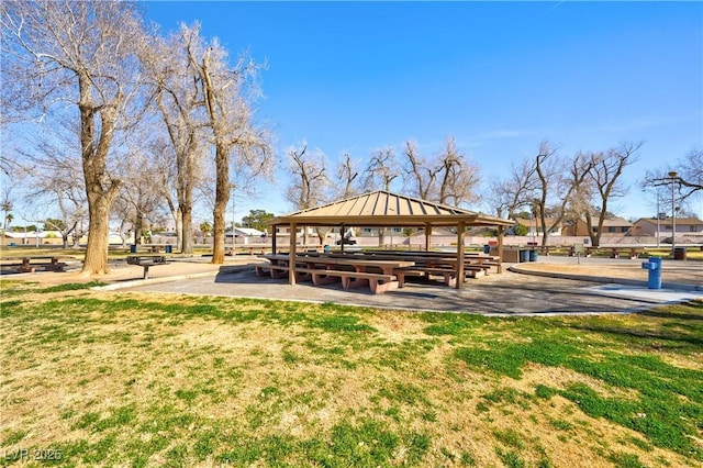 surrounding community with a gazebo and a yard