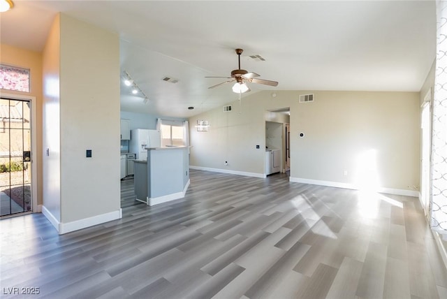 unfurnished living room with vaulted ceiling, wood finished floors, and visible vents