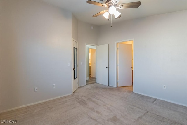 unfurnished bedroom featuring a ceiling fan, lofted ceiling, and light carpet