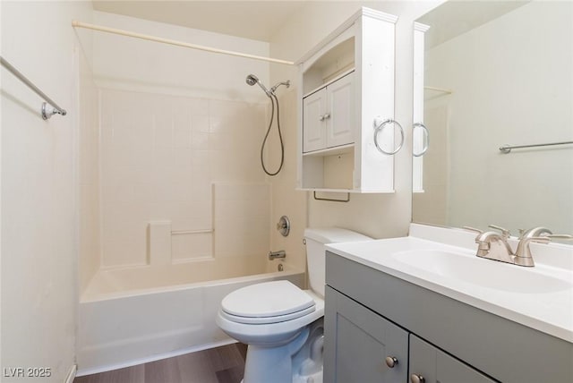 bathroom featuring shower / bathing tub combination, vanity, toilet, and wood finished floors