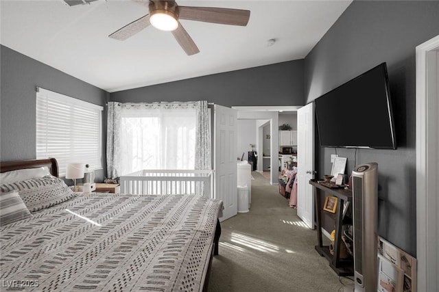 carpeted bedroom featuring ceiling fan and vaulted ceiling