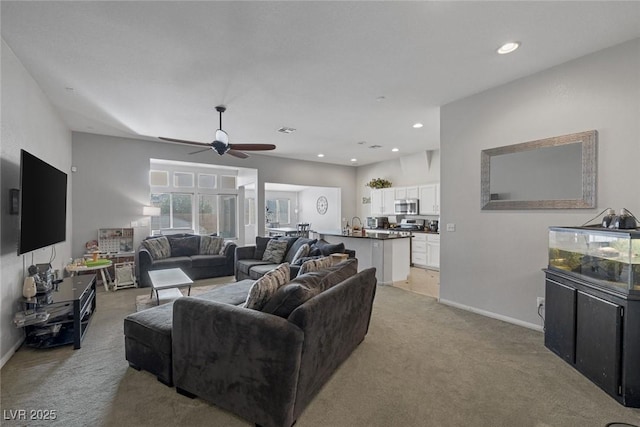 carpeted living room with ceiling fan