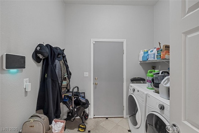 clothes washing area featuring light tile patterned flooring and washing machine and clothes dryer