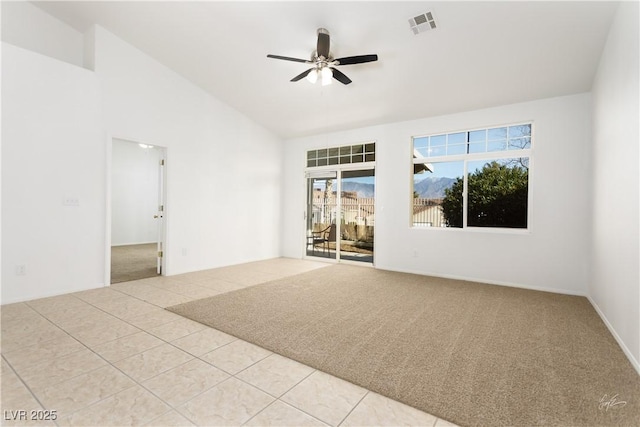 carpeted spare room featuring ceiling fan and high vaulted ceiling