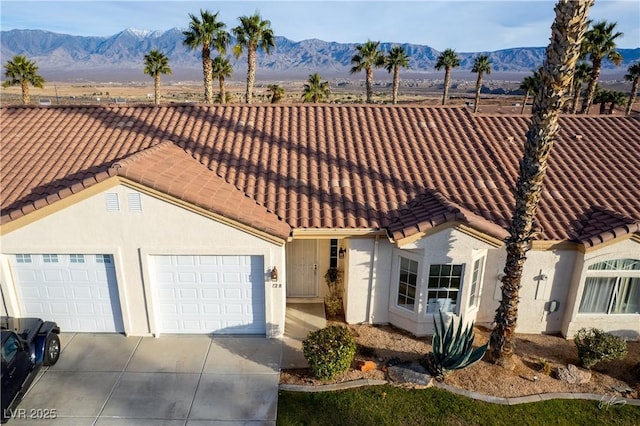 view of front of house featuring a garage and a mountain view