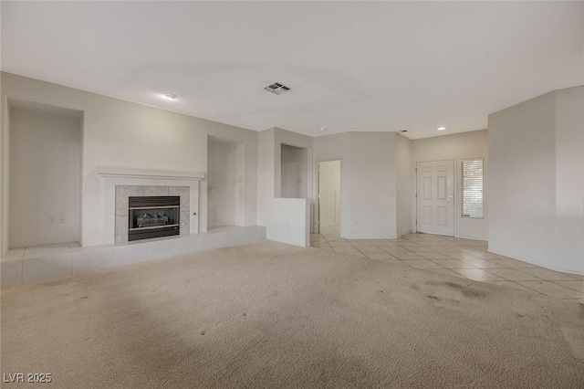 unfurnished living room featuring a fireplace and light colored carpet