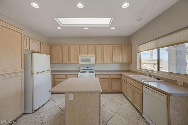 kitchen featuring sink, white appliances, a skylight, a kitchen island, and light brown cabinetry