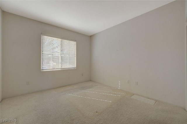 empty room featuring light carpet