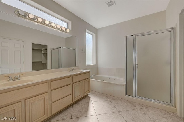 bathroom featuring vanity, tile patterned floors, and shower with separate bathtub