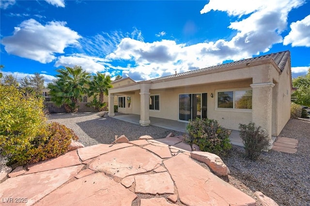 back of house with a patio