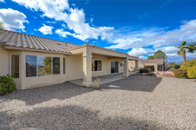 back of house with a patio