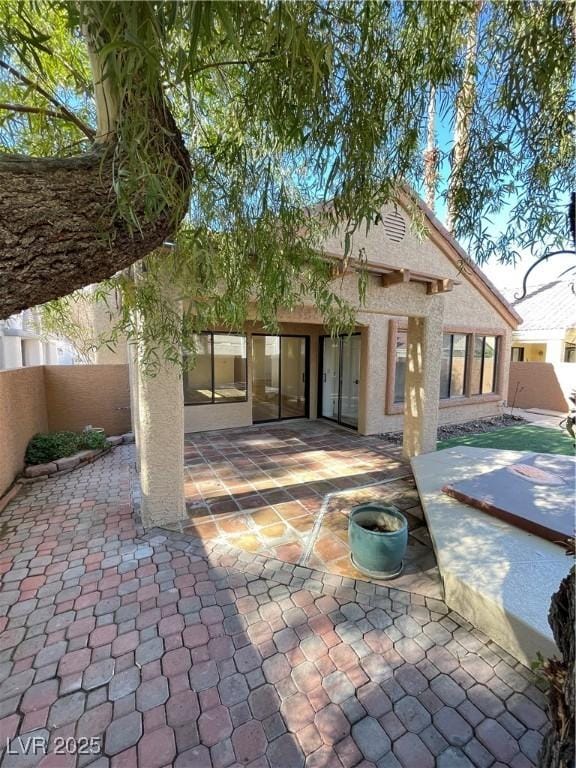 rear view of property featuring a patio