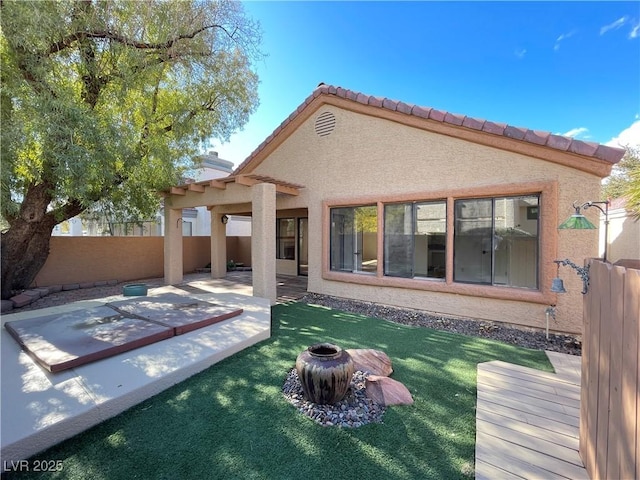 back of property with a patio and a yard