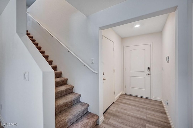 interior space with light wood-style floors, stairway, baseboards, and recessed lighting