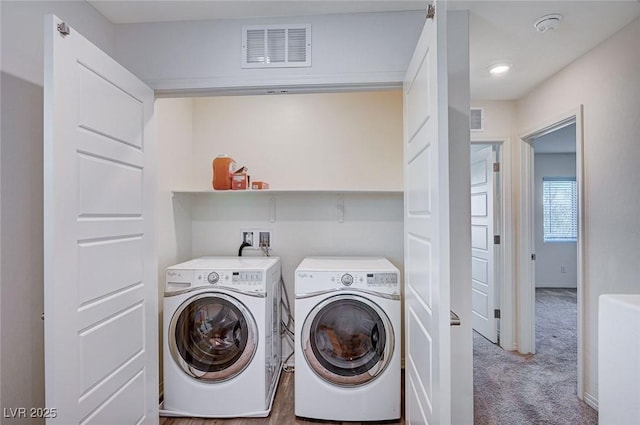 laundry room with laundry area, visible vents, separate washer and dryer, and carpet flooring